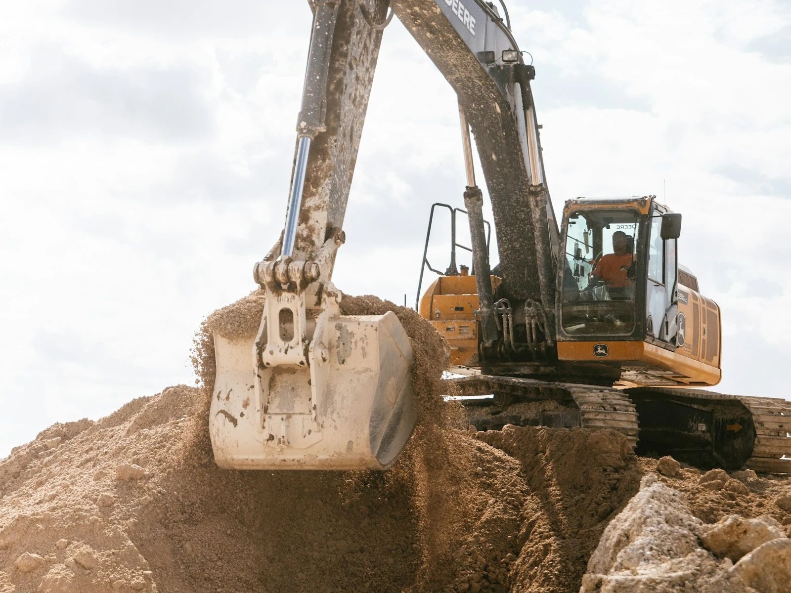 An excavator moving material on a prepared site