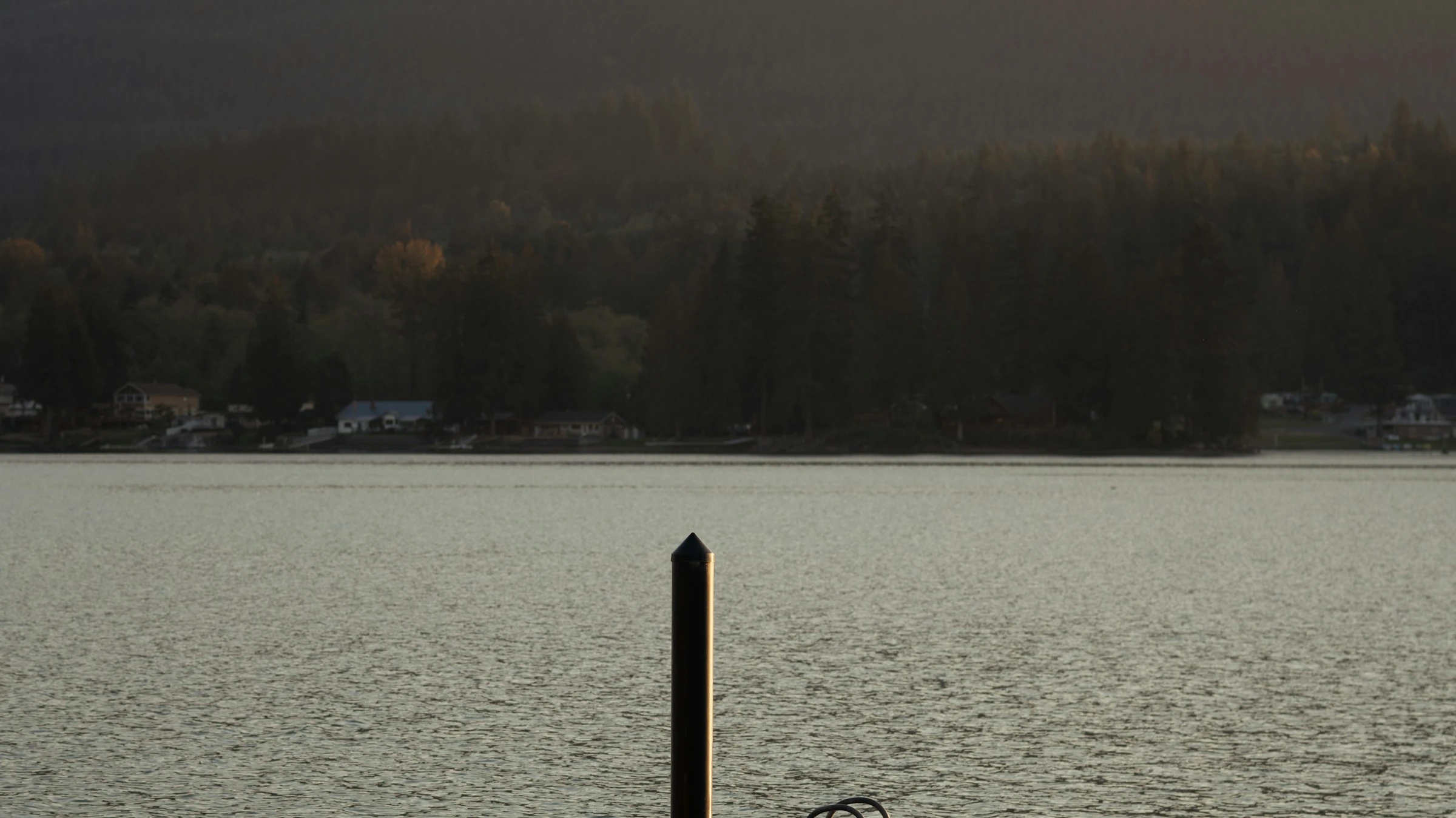 A dock on a quiet lake at dusk in cottage country